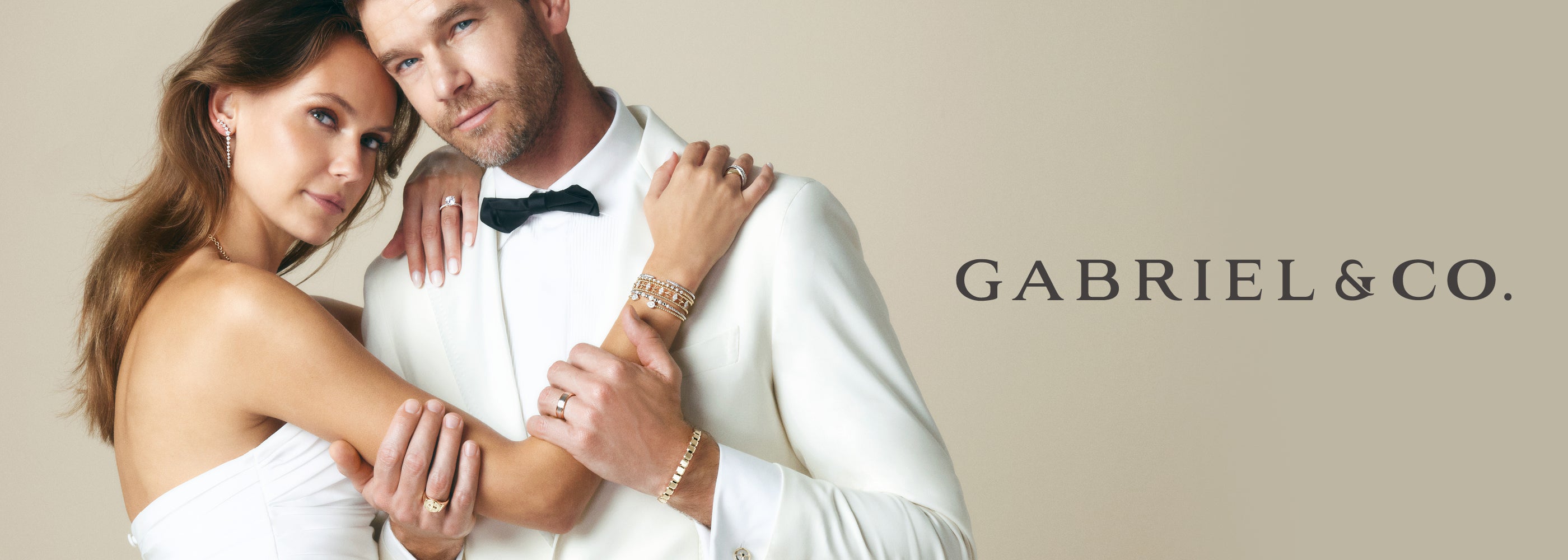 Gabriel & Co. diamond engagemen ring banner bride and groom