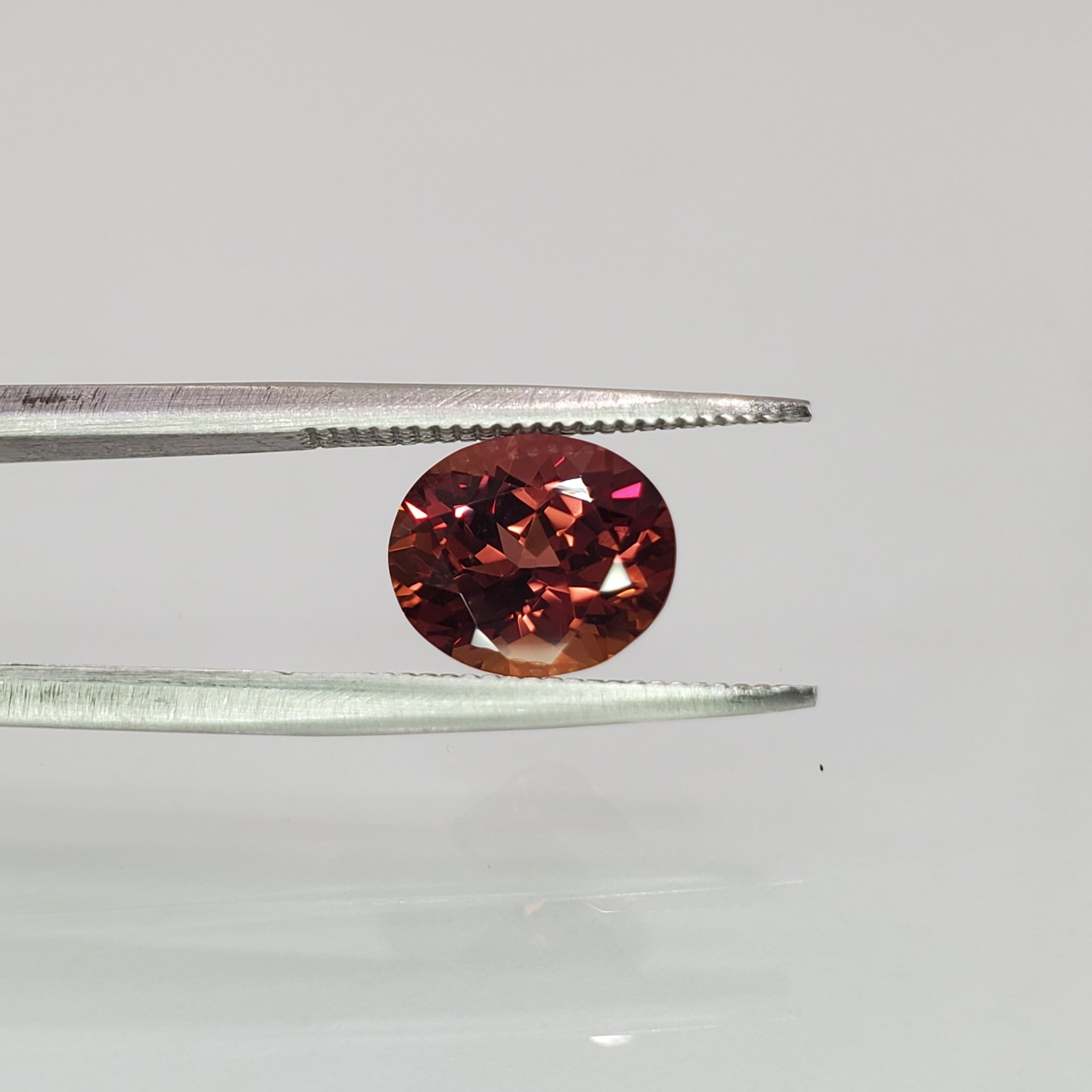 2.63 carat oval cut orange-purple loose sapphire gemstone