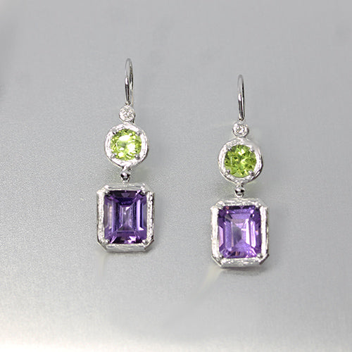 18 karat white gold custom made drop earrings with round peridot and emerald cut amethyst with diamond accents 